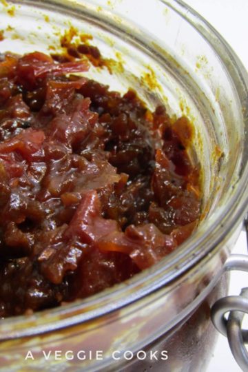 Spicy Tomato Chutney in a glass jar with a spoon