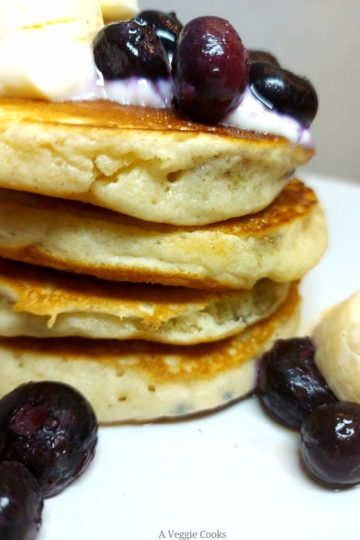 Vegan Blueberry Pancakes topped with vegan yogurt and bananas