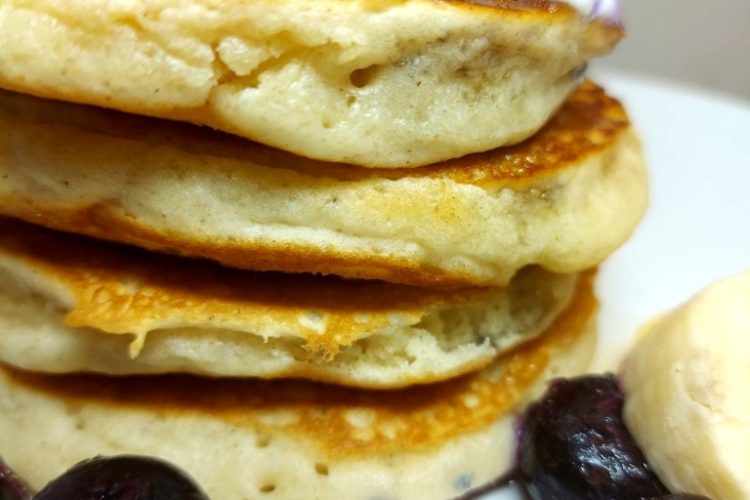 Vegan Blueberry Pancakes topped with vegan yogurt and bananas