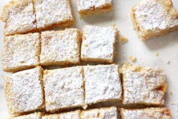 Vegan Apricot crumble bars traybake on a white surface