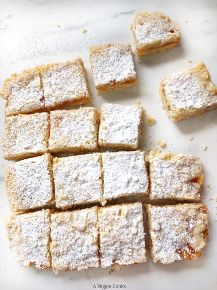 Vegan Apricot crumble bars traybake on a white surface