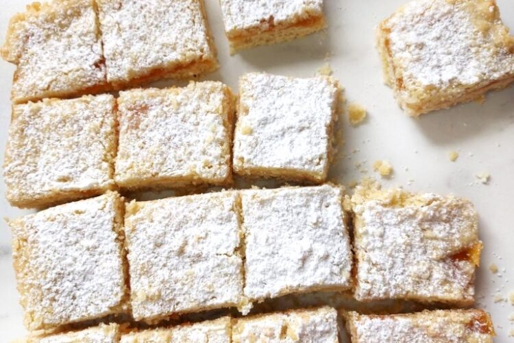 Vegan Apricot crumble bars traybake on a white surface