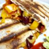 Cooked tortilla wrap with salsa, yellow pepper, kidney beans and vegan cheese