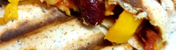 Cooked tortilla wrap with salsa, yellow pepper, kidney beans and vegan cheese