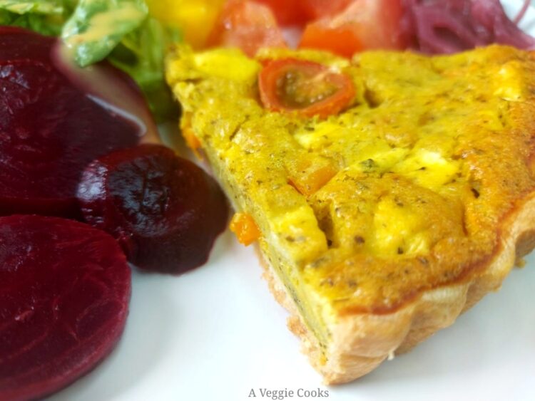 Slice of vegan quiche with sliced beetroot and tomatoes